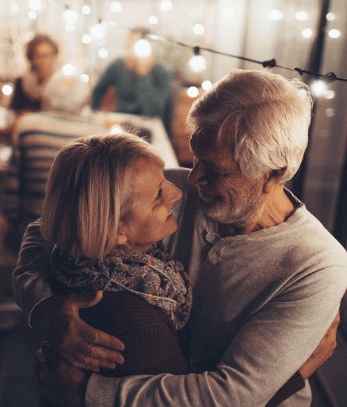 An older couple hugging each other